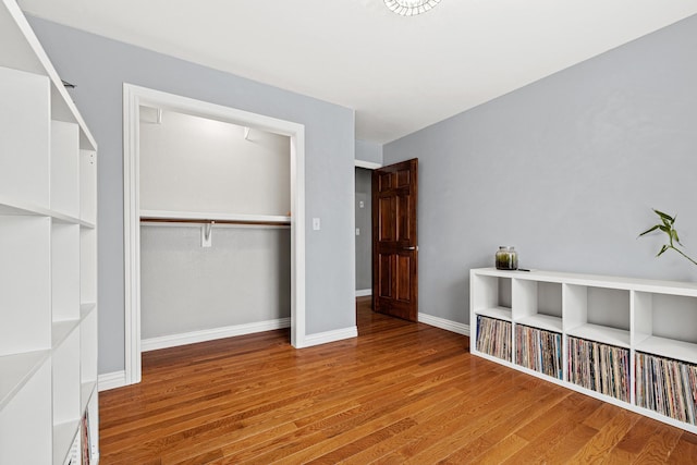 unfurnished bedroom featuring hardwood / wood-style floors and a closet