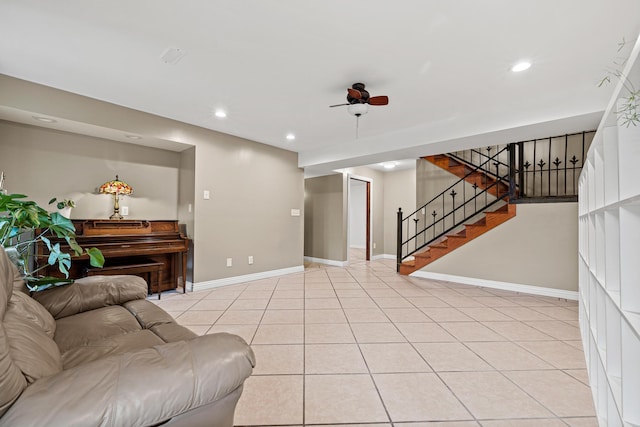 living room with ceiling fan and light tile patterned flooring