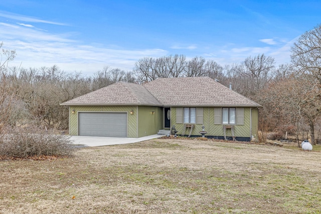 view of front of house featuring a garage and a front lawn