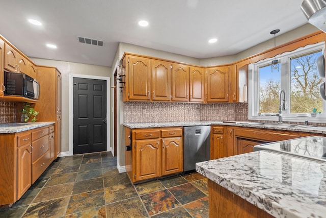 kitchen featuring hanging light fixtures, decorative backsplash, sink, and dishwasher