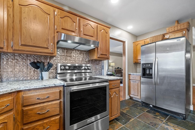 kitchen with stainless steel appliances, backsplash, and light stone counters