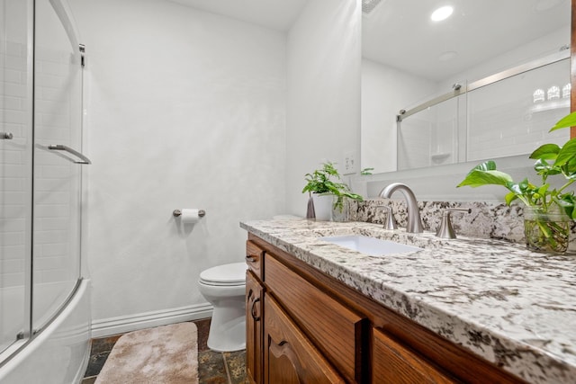 full bathroom with vanity, shower / bath combination with glass door, and toilet