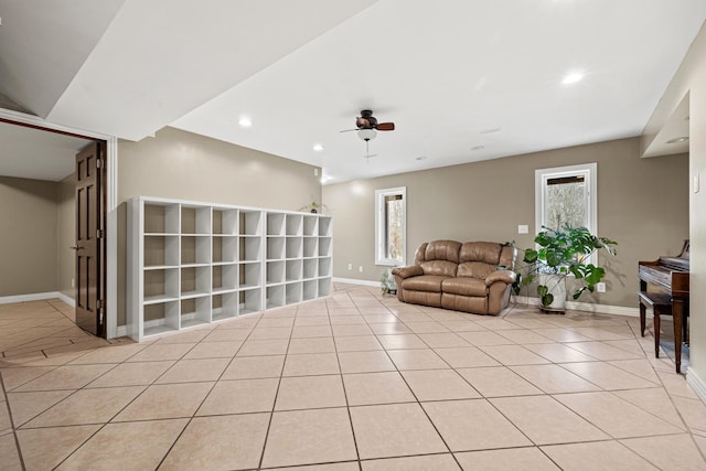 living room featuring light tile patterned floors and ceiling fan