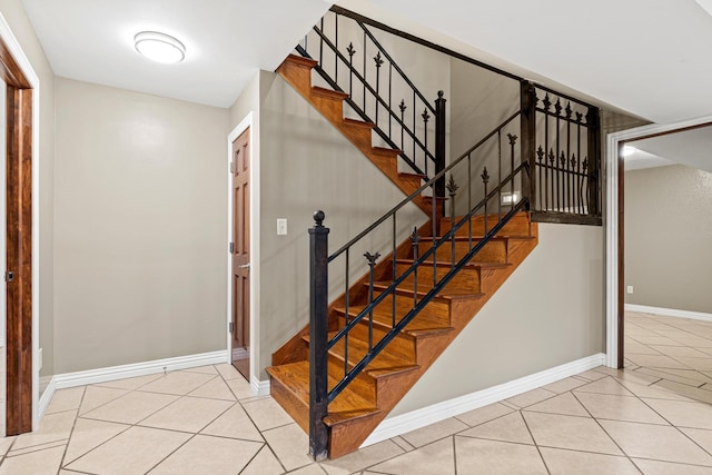 stairway with tile patterned floors