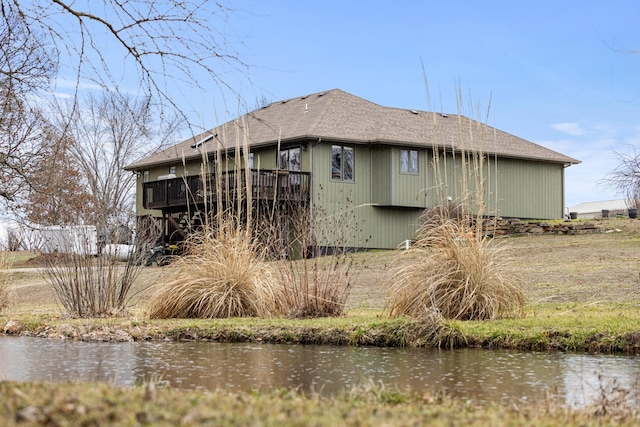 back of property with a water view