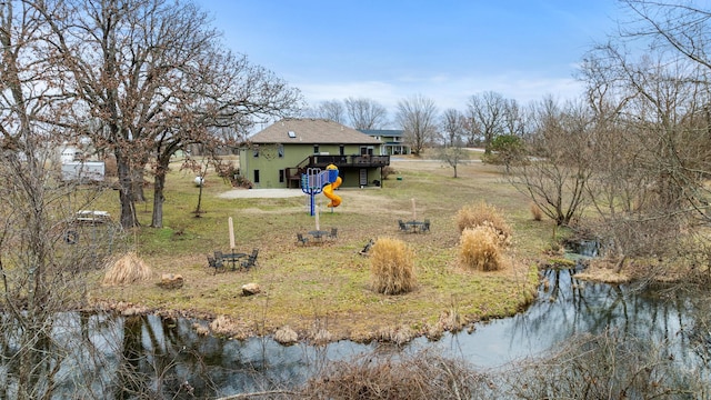 exterior space featuring a deck with water view