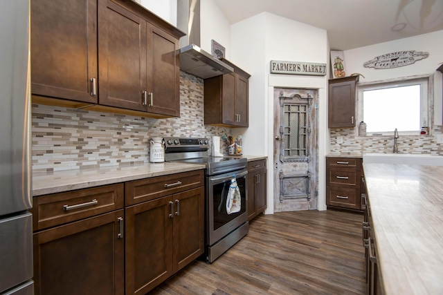 kitchen featuring appliances with stainless steel finishes, dark brown cabinetry, backsplash, and range hood