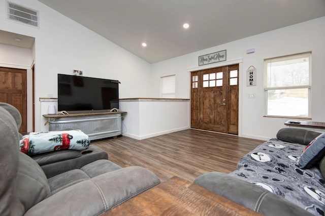 living room featuring lofted ceiling and dark hardwood / wood-style floors