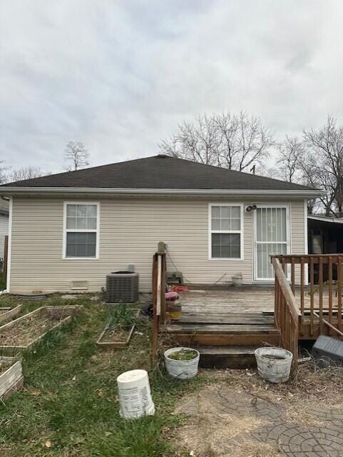 back of house featuring cooling unit and a deck