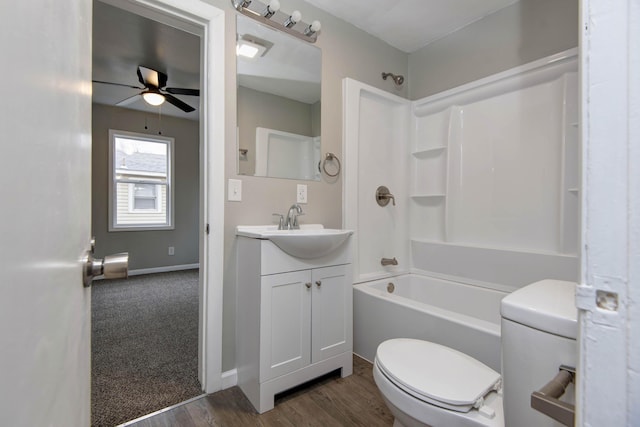 full bathroom featuring toilet,  shower combination, vanity, ceiling fan, and hardwood / wood-style floors