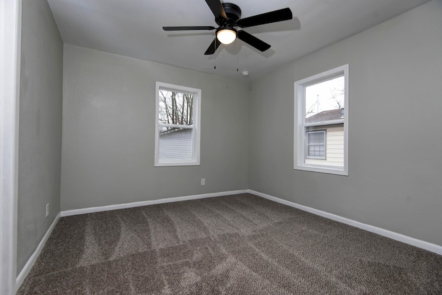 carpeted spare room with ceiling fan