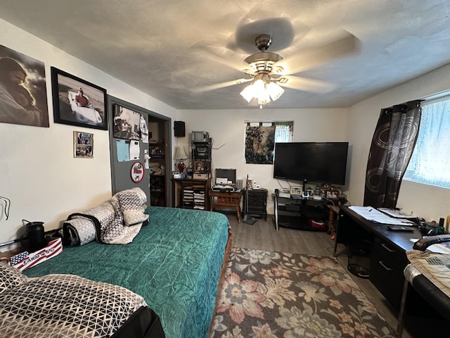 bedroom featuring wood-type flooring and ceiling fan