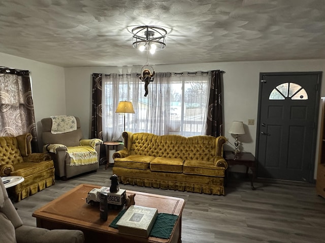 living room with hardwood / wood-style floors and a textured ceiling