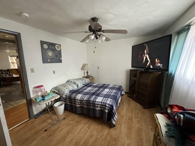 bedroom featuring ceiling fan and light hardwood / wood-style flooring