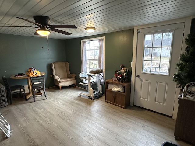 living area with a healthy amount of sunlight, wooden ceiling, and light hardwood / wood-style flooring