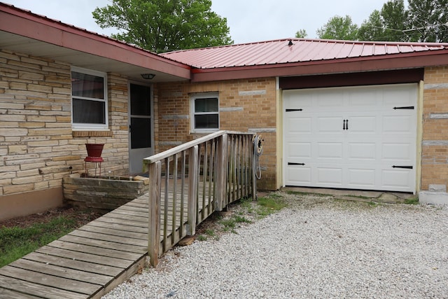 doorway to property with a garage