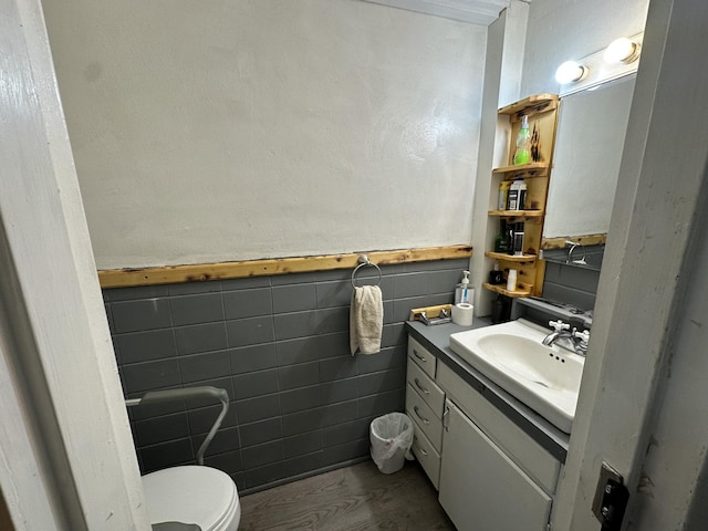 bathroom featuring vanity, tile walls, and toilet