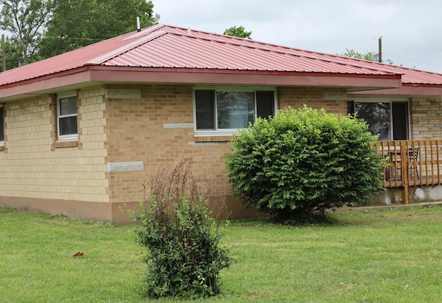 view of side of home featuring a yard