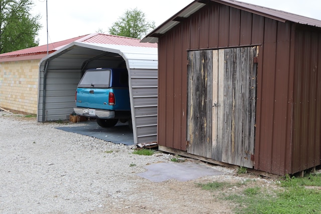 view of outbuilding with a carport