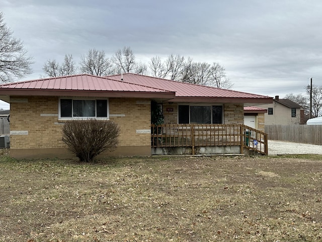 ranch-style house with central AC and a front yard