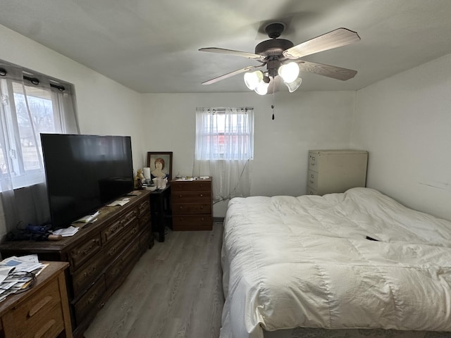 bedroom with ceiling fan and light wood-type flooring