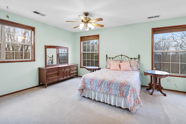 bedroom featuring ceiling fan and light carpet