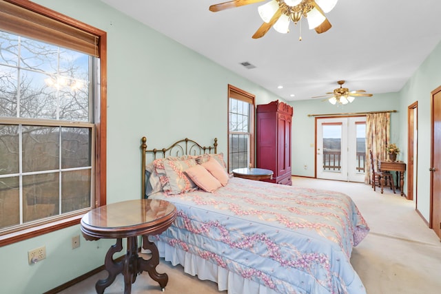 bedroom with multiple windows, light carpet, access to exterior, and ceiling fan