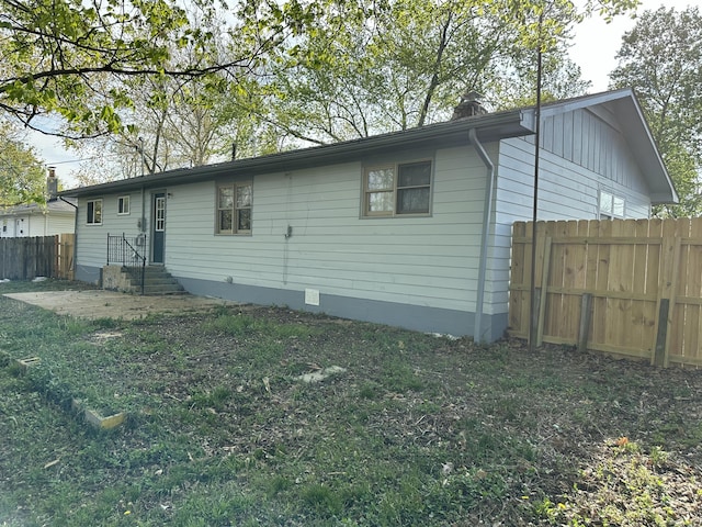back of house featuring fence and crawl space