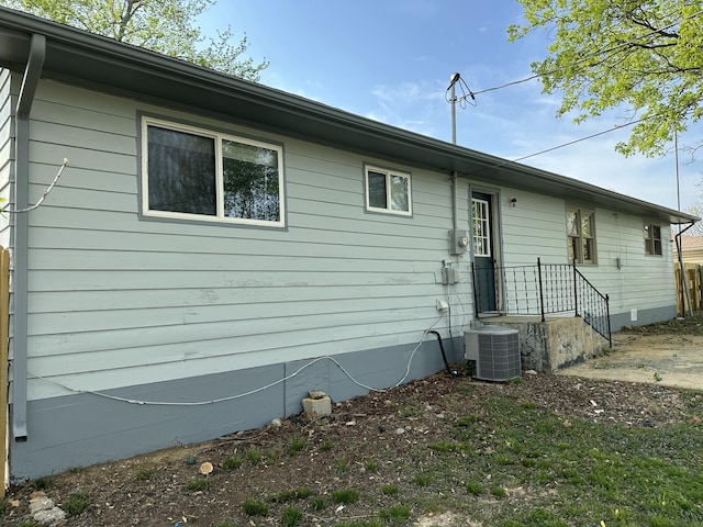 back of house featuring central AC unit and crawl space