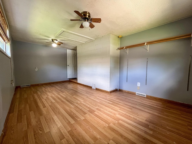 210 Pine St, West Plains, MO 65775 - unfurnished bedroom with attic access, wood finished floors, a textured ceiling, and ceiling fan