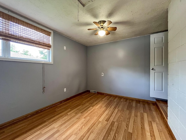 210 Pine St, West Plains, MO 65775 - unfurnished room featuring light wood finished floors, a textured ceiling, attic access, and ceiling fan