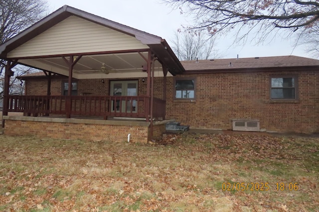 rear view of house with french doors and a yard