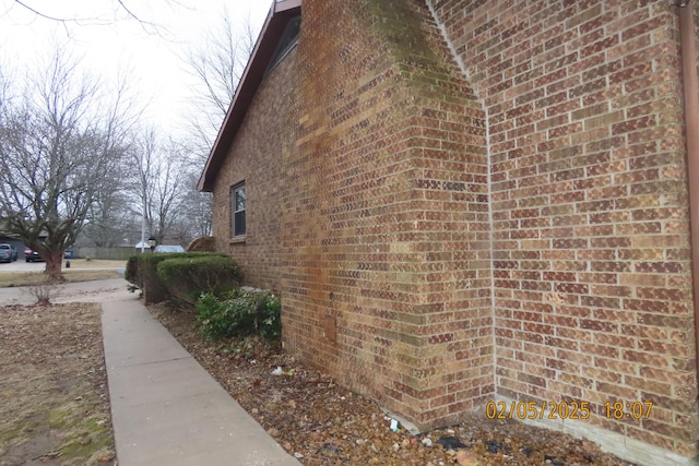 view of side of home with brick siding