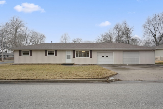 ranch-style home with a garage and a front lawn