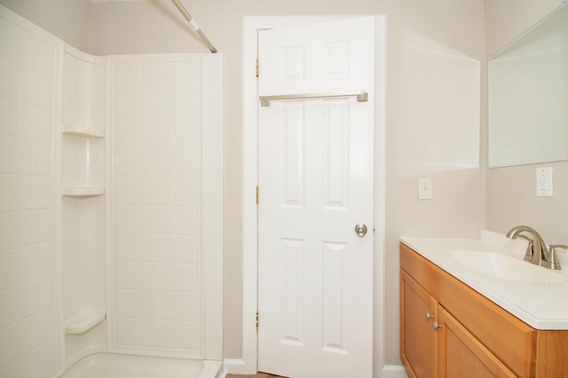 bathroom featuring vanity and a shower