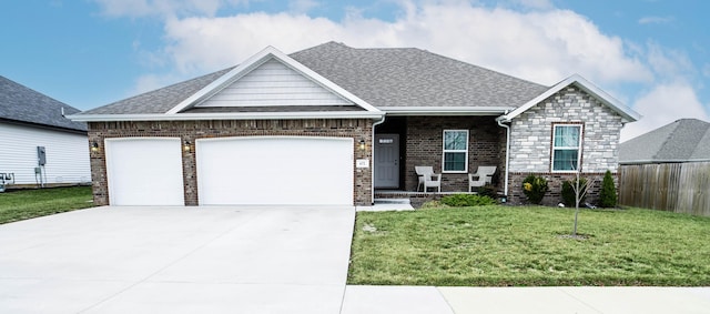 craftsman-style house featuring a garage and a front yard