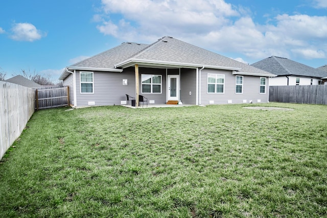 back of property with a yard and a patio area