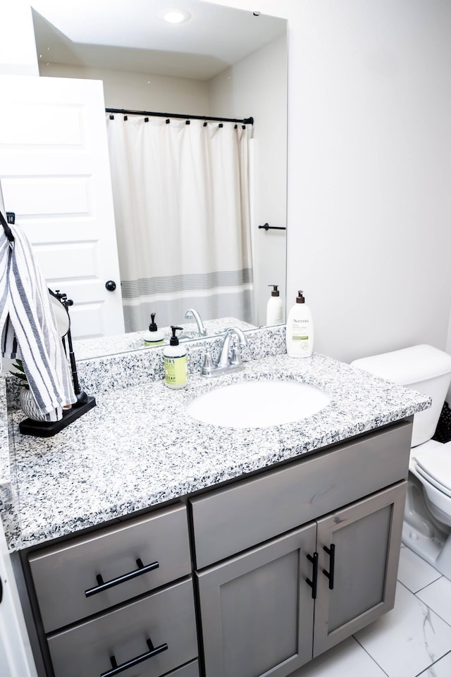 bathroom featuring vanity and toilet