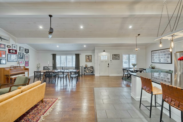 living room featuring crown molding, a healthy amount of sunlight, and hardwood / wood-style floors