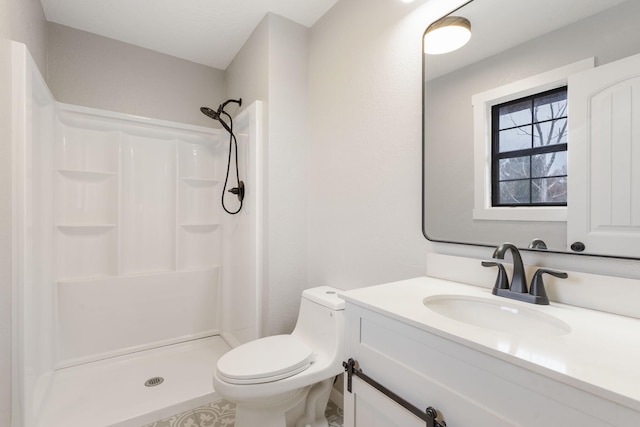 bathroom featuring vanity, toilet, and a shower