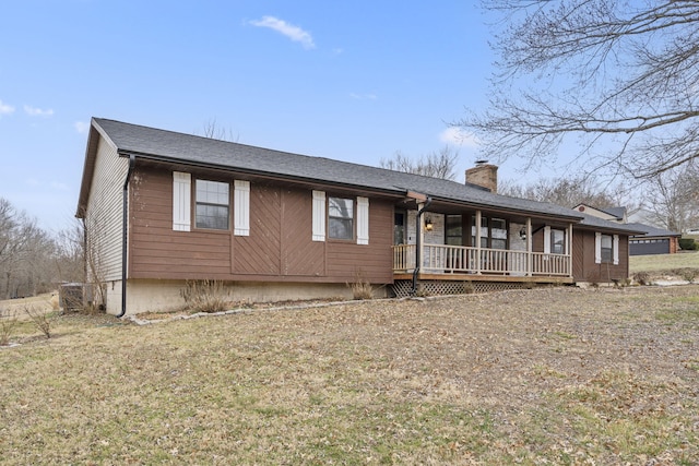 ranch-style home with a front yard and covered porch