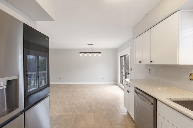 kitchen featuring decorative light fixtures, dishwasher, light stone countertops, and white cabinets