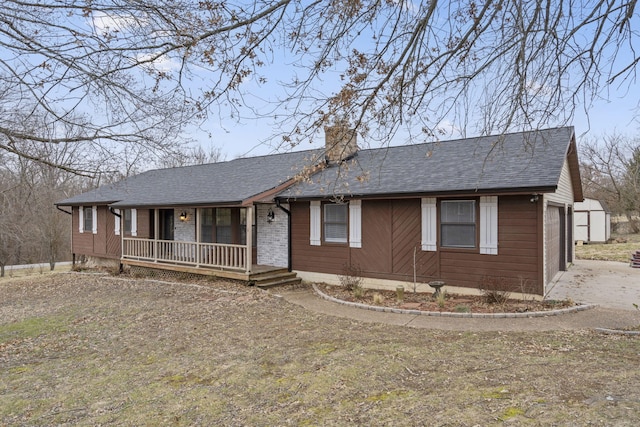 ranch-style home with a porch and a garage