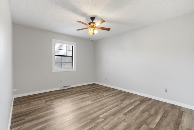 unfurnished room featuring hardwood / wood-style flooring, a textured ceiling, and ceiling fan