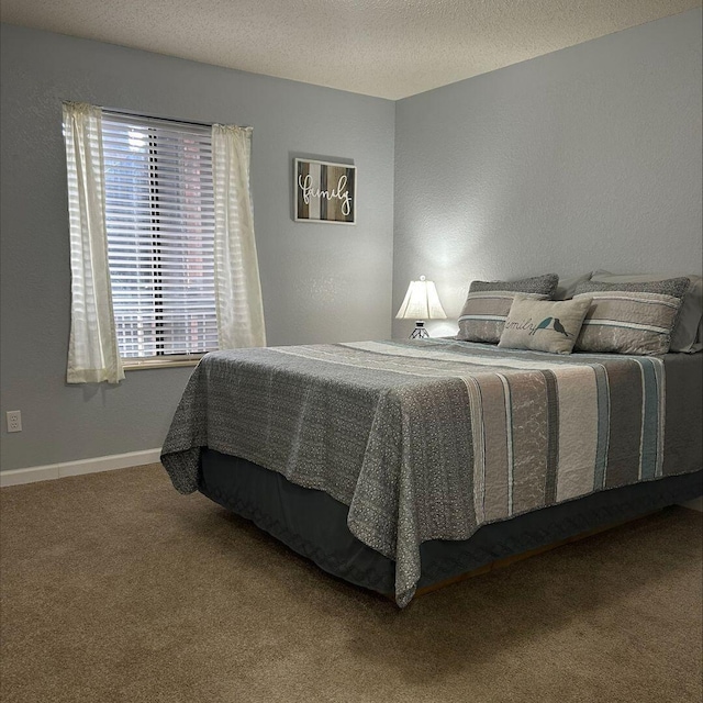 bedroom with carpet and a textured ceiling