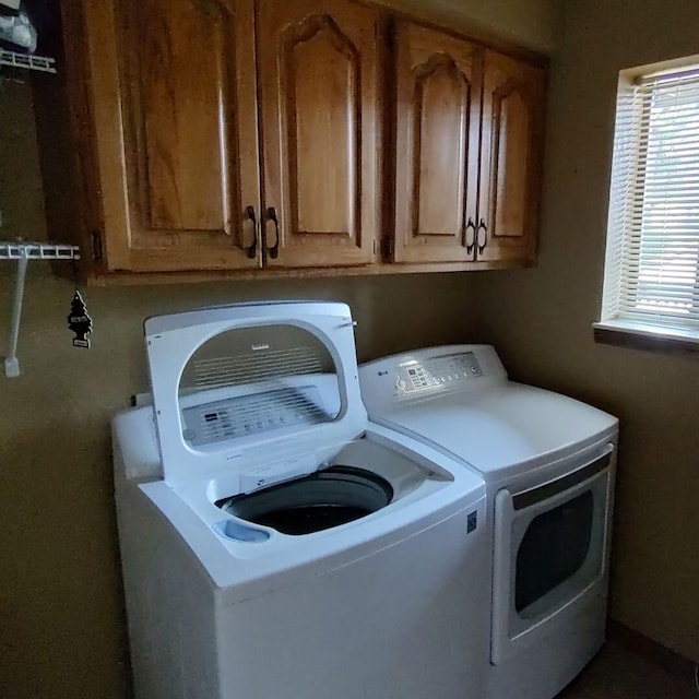 laundry room with cabinets and separate washer and dryer