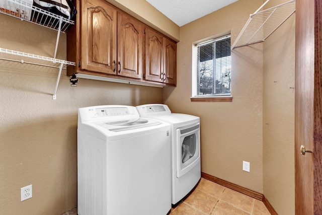 laundry room with separate washer and dryer and cabinets