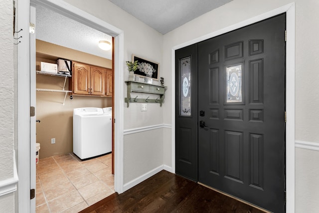 entryway featuring washer and dryer and light hardwood / wood-style flooring