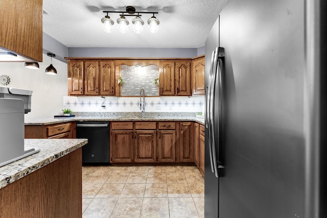 kitchen with backsplash, stainless steel refrigerator, decorative light fixtures, and dishwasher