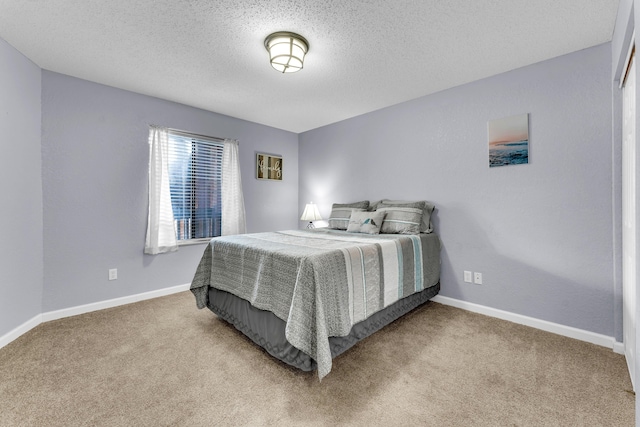 carpeted bedroom with a textured ceiling